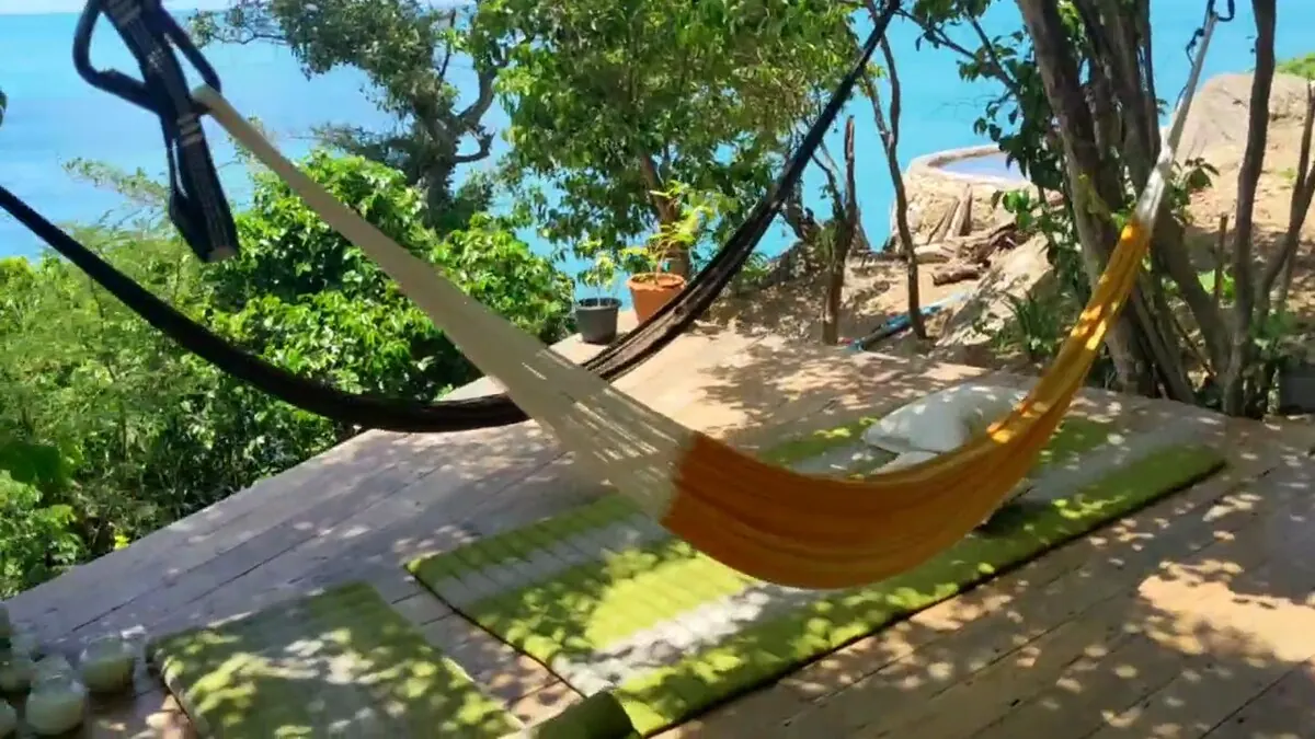 Yellow hammock in the trees above the sea