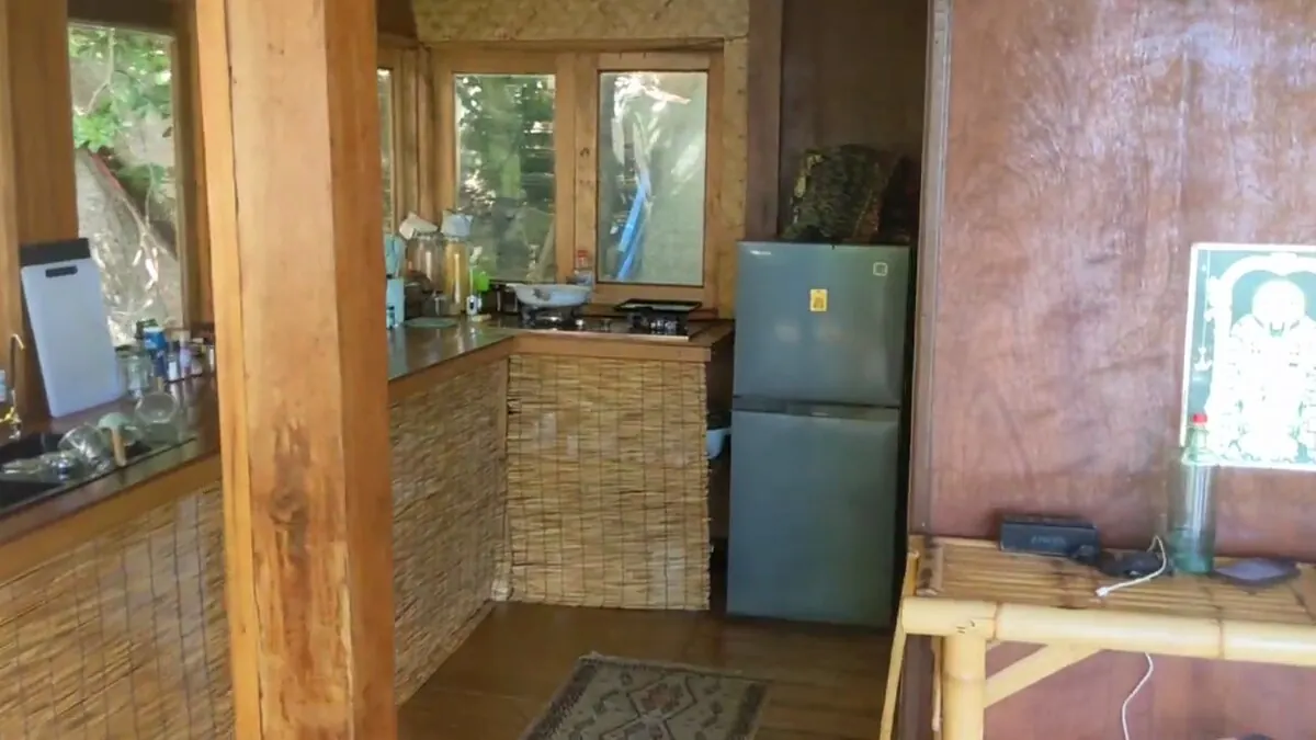 Kitchen with fridge-freezer and cooking utensils