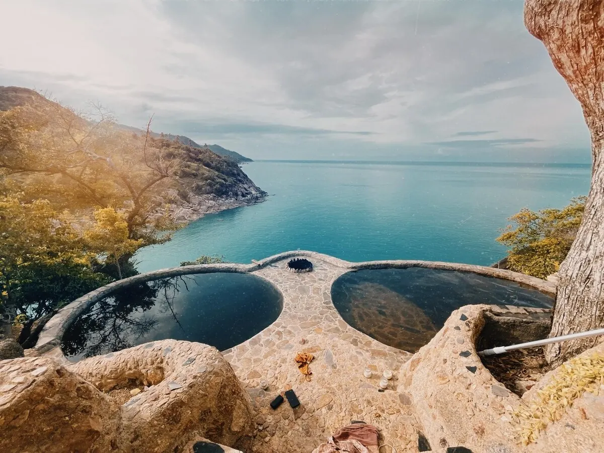 Rock-cut private pools on the cliff edge overlooking the sea at Why Nam, Koh Phangan