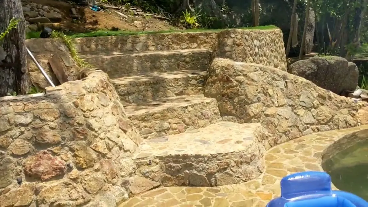 Stone steps leading down to the private pools