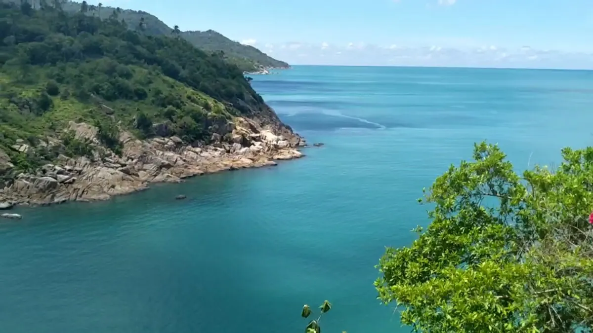 Calm turquoise water and wooded headland seen from the villa